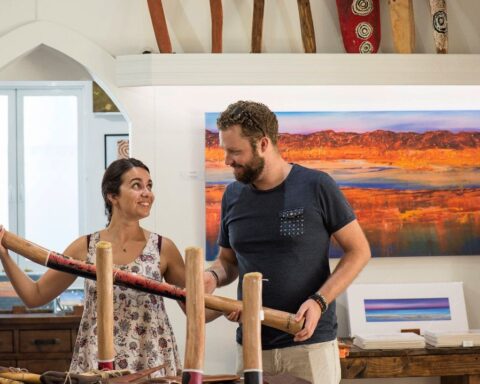 A couple looking at a didgeridoo Yubu Napa Art Gallery