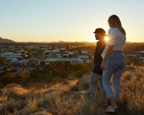 A Couple standing on Anzac Hill looking at Alice Springs