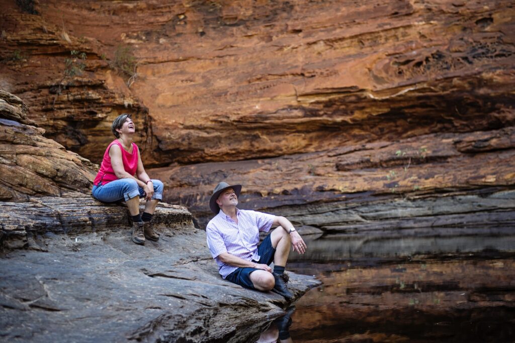 Visitors explore at the Garden of Eden in Kings Canyon.

Go on a drive out to Watarrka National Park, home of Kings Canyon. Walk along the red rock cliffs and take in views of the forest of palms below. Kings Canyon is a majestic destination featuring 100m-high sandstone walls, palm-filled crevices and views that stretch across the desert.